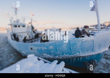 The Icebreaker ship trapped in ice tries to break and leave the bay between the glaciers Stock Photo