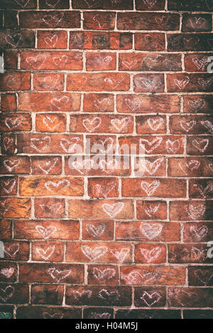 Chalked love hearts on a wall in Glastonbury, Somerset, England. Vintage filter applied Stock Photo