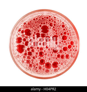 Top view of red frothy drink with foam and bubbles in simple glass. Isolated on white with clipping path Stock Photo