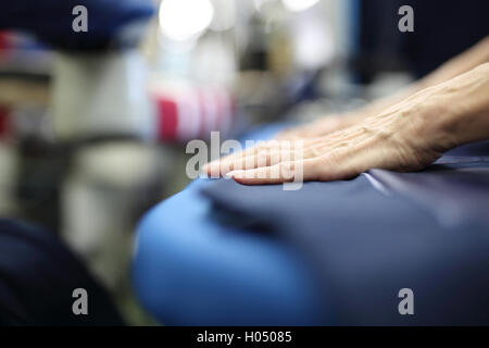 Clothing industry. Ironing steam. Presser in sewing clothes pressed. Stock Photo