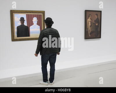 Paris, France. 20th Sep, 2016. A man stands in front of paintings by Rene Magritte in Paris, France, 20 September 2016. The exhibition Magritte. The Treachery of Images runs from 21 September 2016 until 23 January 2017. PHOTO: SABINE GLAUBITZ/DPA/Alamy Live News Stock Photo