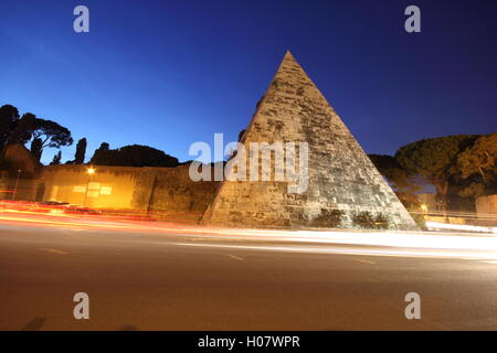 a stunning shot of the Egyptian style pyramid in the city of Rome by night, 'Piramide Cestia', Rome, Italy Stock Photo