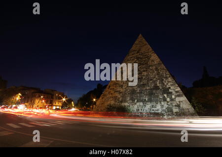 a stunning shot of the Egyptian style pyramid in the city of Rome by night, 'Piramide Cestia', Rome, Italy Stock Photo
