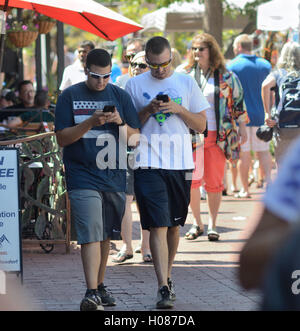 Walking and using smart phones on Pearl St. Mall Stock Photo