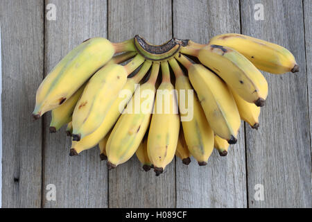 Ducasse Bananas or also known as Sugar Bananas on wooden board Stock Photo
