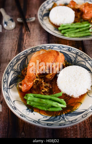 Vietnamese rice with fried chicken legs and green beans on the table Stock Photo