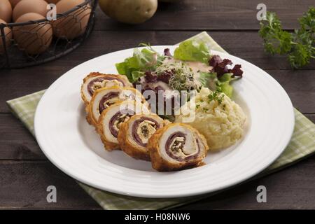 Plate of Ayam with potato and herbs on the table in restaurant Stock Photo