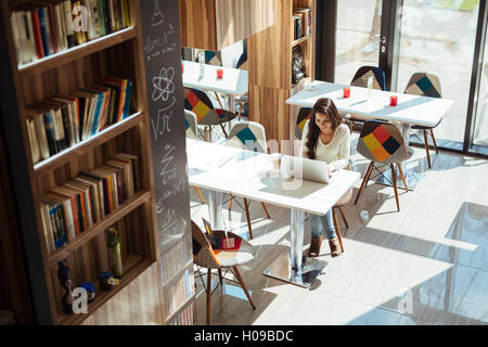 Beautiful brunette studying on notebook Stock Photo