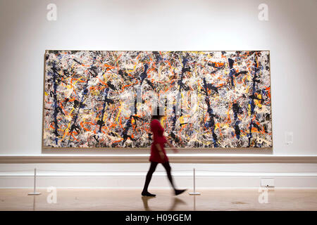 A woman walks past 'Blue Poles', 1952 by Jackson Pollock during a photocall at the Royal Academy of Arts, London.