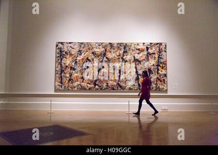 A woman walks past 'Blue Poles', 1952 by Jackson Pollock during a photocall at the Royal Academy of Arts, London.