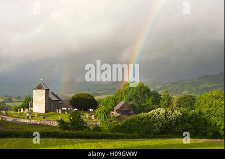 A rainbow over St. David's Church in the tiny Welsh hamlet of Llanddewir Cwm, Powys, Wales, United Kingdom, Europe Stock Photo