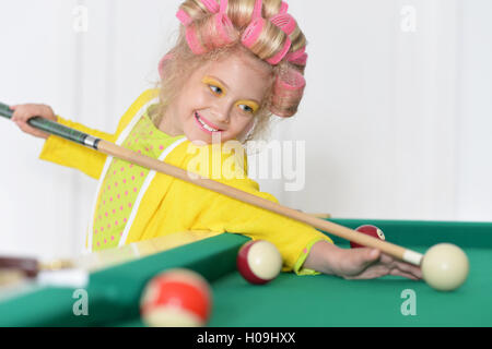 little girl playing billiard Stock Photo