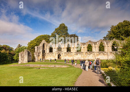 A group of overseas tourists with a German speaking guide at St Mary's Abbey, York, North Yorkshire, England, UK Stock Photo