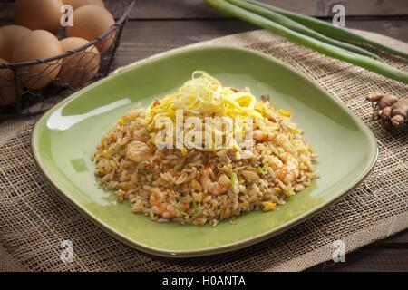 Plate of fried rice with shrimps on the table in restaurant Stock Photo
