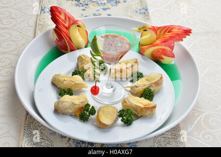 Fried wanton with cocktail and duck apple on white plate in restaurant Stock Photo