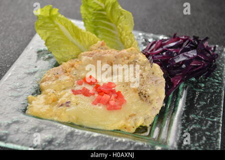 Bread cake with salad and minced tomato on plate Stock Photo