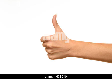 Side view of female hand showing thumbs up sign against white background Stock Photo