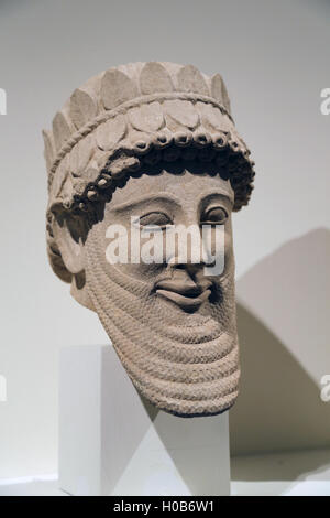 Head of a man. Limestone. Cypriot, Archaic, early 5th C. B.C. From Temple at Golgoi. Hellenization of the Assyrian type of head. Stock Photo