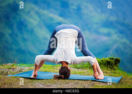 Woman doing Ashtanga Vinyasa Yoga asana Prasarita padottanasana Stock Photo