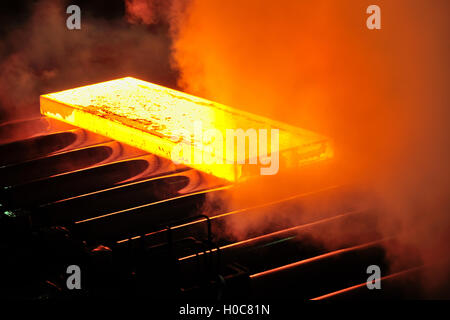 Hot steel plate on conveyor Stock Photo
