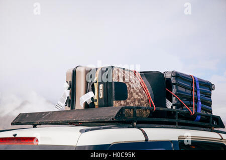 Luggages and Bags arranged on the car roof ready for a trip in sky background Stock Photo