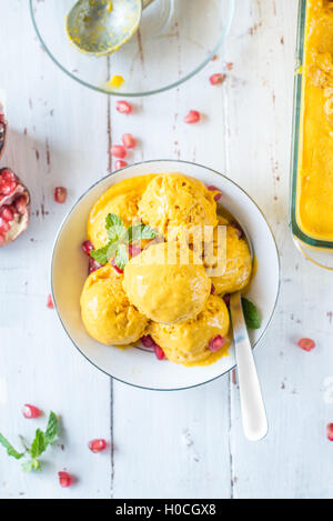 Mango and tender coconut ice cream on wooden background Stock Photo