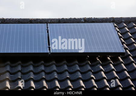 black premium roof mounted solar panels in a domestic solar panel installation in the uk Stock Photo