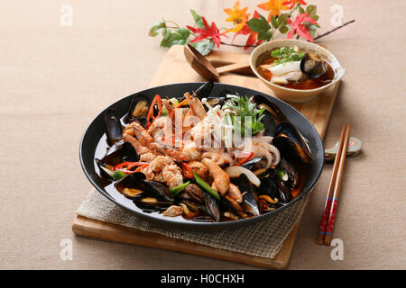 Cool and spicy seafood soup taste with octopus, clams, mussels and shrimps Stock Photo