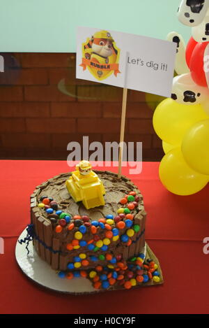 Paw Patrol birthday party balloon twisting and chocolate cake Stock Photo