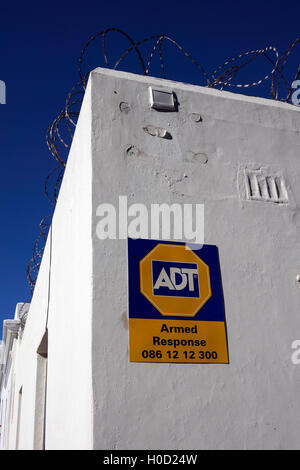 ADT Armed Response sign on a wall with barbed wire , Cape Town, South Africa. Stock Photo