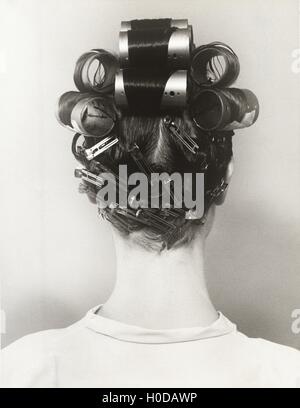 Rear view of woman with curlers in her hair Stock Photo