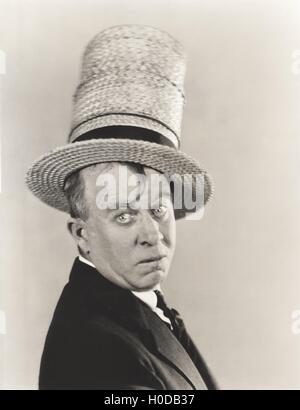 Man wearing stovepipe straw hat Stock Photo