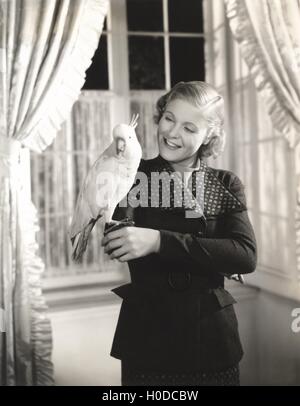 Cockatoo perched on woman's hand Stock Photo