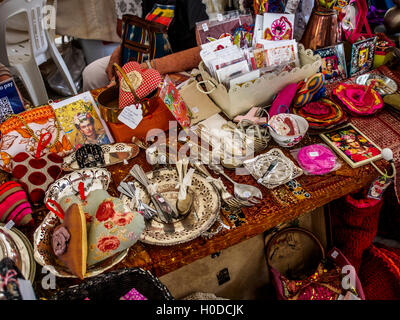 Trinkets, seconds and other collectables on sale in a market stall Stock Photo