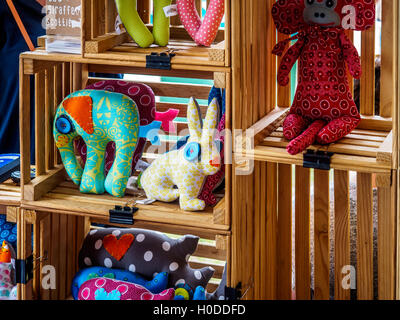Handmade children's dolls and toys on sale in a market stall Stock Photo