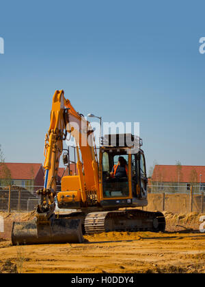 Digger or earth mover or backhoe working on a construction or building site Stock Photo