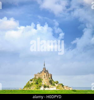 Mont Saint Michel monastery landmark and green field. Unesco heritage site. Normandy, France, Europe. Stock Photo