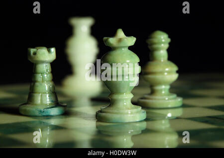chessboard and alabaster chess on a black background Stock Photo