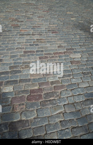 Cobble stones in a cobbled street. Granite sett stones placed in rows. Stock Photo
