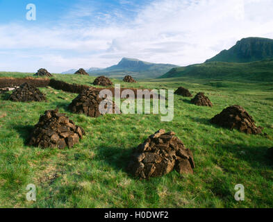 Peat cuttings and stacks from the Quiraing road between Staffin and Uig with the Trotternish ridge, beyond. Isle of Skye, Scotland Stock Photo