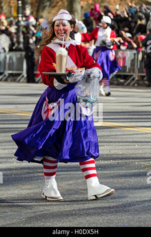 A clown dressed as a malt shop waitress walks in the Macy's Thanksgiving Day Parade, New York City.