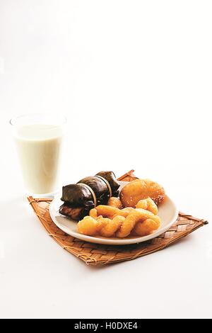 Fried crispy baked asian cake with glass of milk on white background Stock Photo