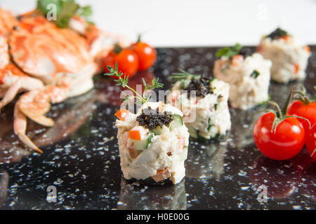 Crab Meat Salad with Black Caviar Horizontal tomato and crabs Stock Photo