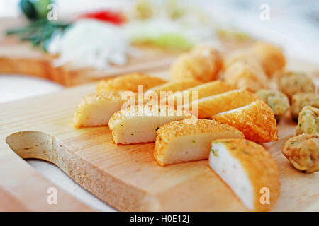 Sliced fish cake laksa on wooden cutting board in kitchen Stock Photo