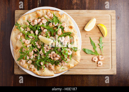 Baby shrimps Pizza with lemon and vegetables on wooden cutting board Stock Photo