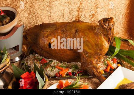 Roasted whole goat fuel ala with vegetables buffet in the Middle East Stock Photo