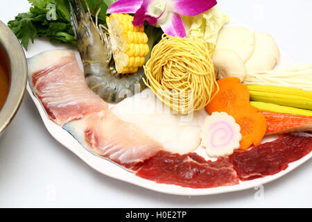 Vietnamese hot pot of shrimp, beef, fresh fish, corn, mushroom, carrot and dried noodle Stock Photo