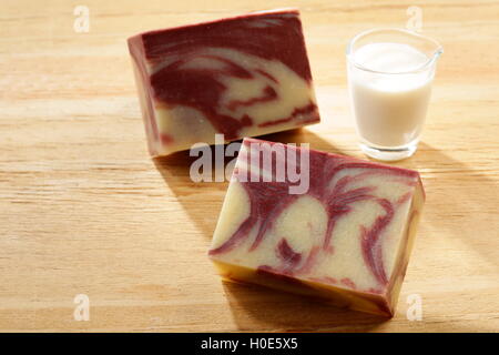 Charcoal soap deep cleansing with glass of milk on wooden table Stock Photo