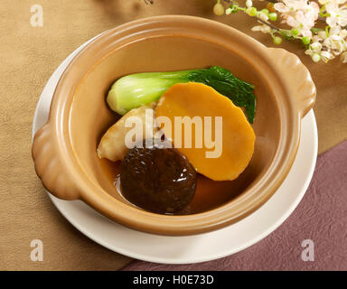 South African sauteed abalone with mushroom and green cabbage in chinese bowl Stock Photo