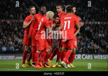 Liverpool's Philippe Coutinho (centre) celebrates scoring his teams second goal during the EFL Cup, Third Round match at the iPro Stadium, Derby. Stock Photo